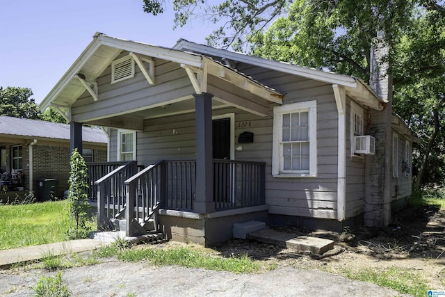 1228 19th Pl SW, Birmingham, AL 35211 - shotgun-style home with covered porch, a chimney, and cooling unit