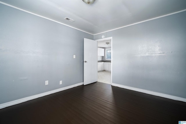 1228 19th Pl SW, Birmingham, AL 35211 - empty room featuring wood finished floors, baseboards, and crown molding