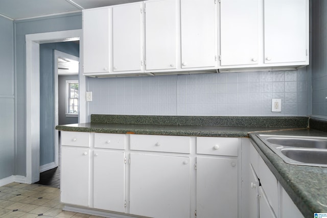 1228 19th Pl SW, Birmingham, AL 35211 - kitchen featuring white cabinets, decorative backsplash, and dark countertops