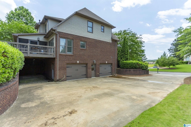 1020 Dunsmore Dr, Chelsea, AL 35043 - view of home's exterior with brick siding, an attached garage, concrete driveway, and a wooden deck
