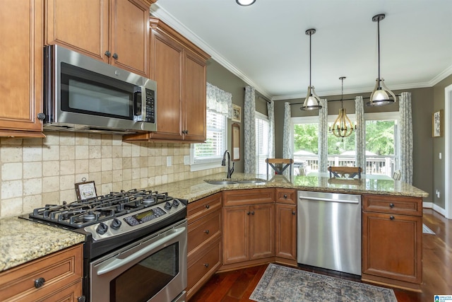 1020 Dunsmore Dr, Chelsea, AL 35043 - kitchen featuring appliances with stainless steel finishes, a sink, dark wood-type flooring, brown cabinetry, and a peninsula