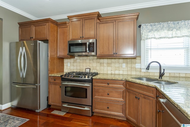 1020 Dunsmore Dr, Chelsea, AL 35043 - kitchen featuring appliances with stainless steel finishes, a sink, brown cabinetry, dark wood finished floors, and crown molding