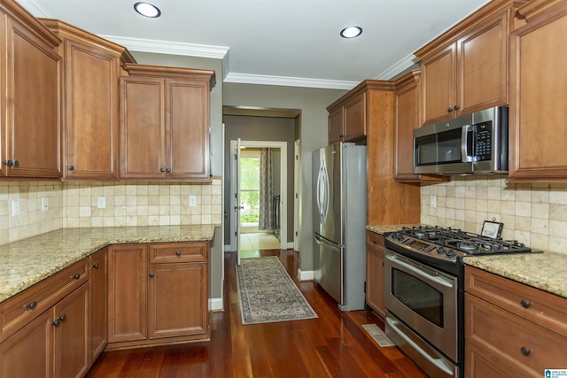 1020 Dunsmore Dr, Chelsea, AL 35043 - kitchen with stainless steel appliances, brown cabinets, dark wood-style flooring, recessed lighting, and crown molding