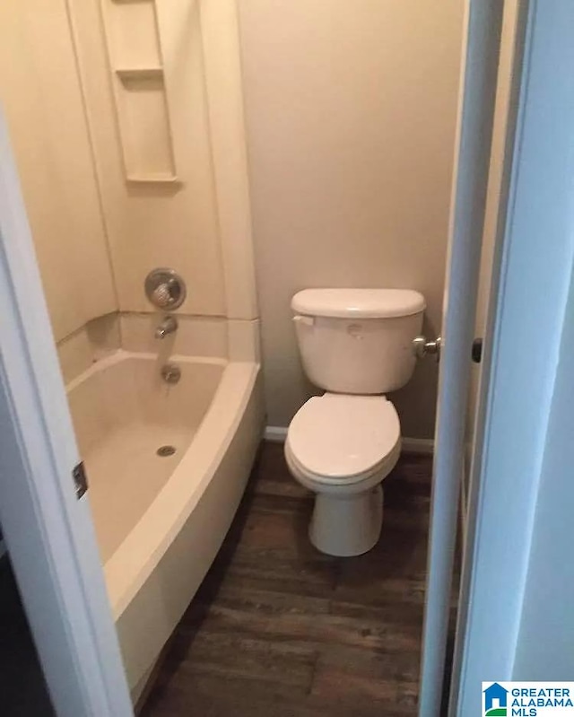 421 Valley Crest Dr, Birmingham, AL 35215 - bathroom with wood finished floors, toilet, washtub / shower combination, and baseboards