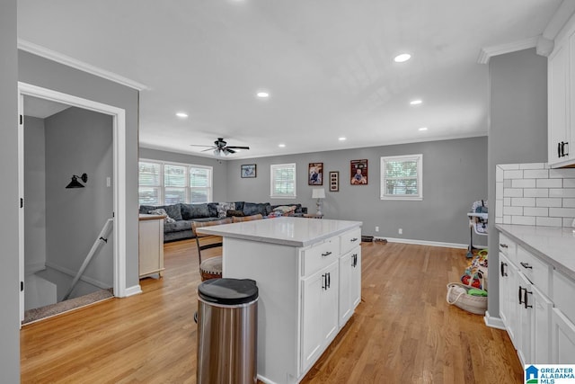 1115 Park Ave, Oneonta, AL 35121 - kitchen with light wood-type flooring, crown molding, recessed lighting, baseboards, and white cabinetry