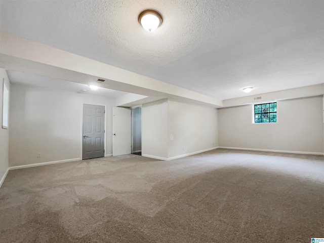 1012 Christopher Dr, Birmingham, AL 35215 - below grade area featuring baseboards, light colored carpet, and a textured ceiling