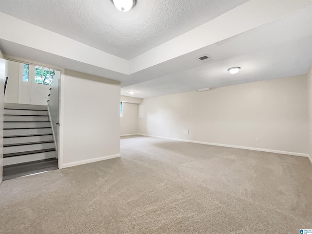 1012 Christopher Dr, Birmingham, AL 35215 - basement with carpet flooring, baseboards, stairs, and a textured ceiling