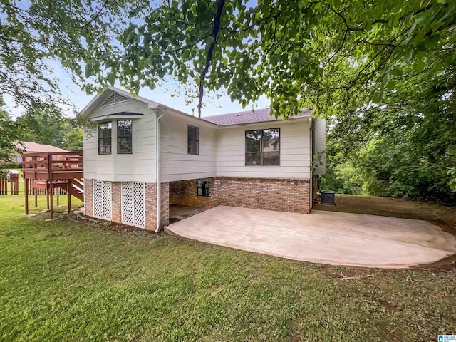 1012 Christopher Dr, Birmingham, AL 35215 - back of property featuring brick siding, a patio area, a lawn, and stairs