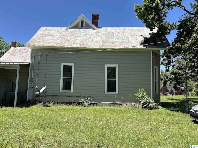120 2nd St, Jemison, AL 35085 - view of property exterior with a chimney, a yard, cooling unit, and metal roof