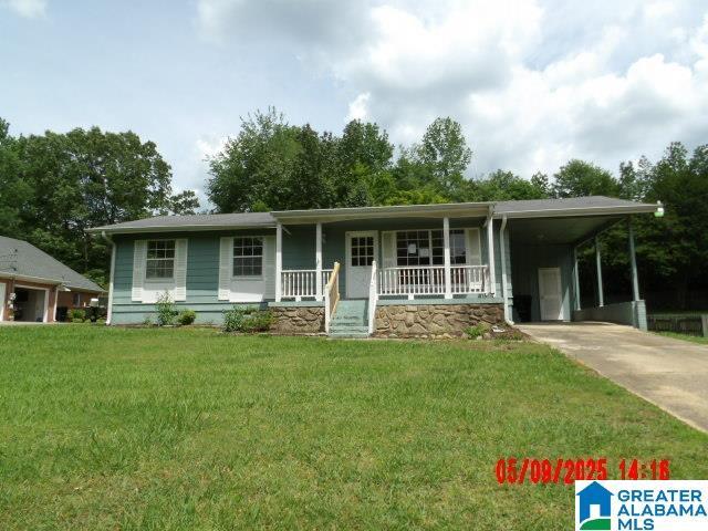 8421 Azalea Dr, Pinson, AL 35126 - view of front of house featuring concrete driveway, a porch, an attached carport, and a front yard