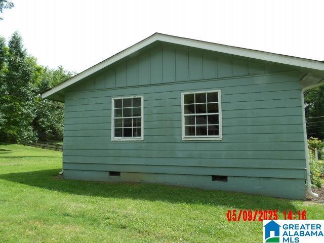 8421 Azalea Dr, Pinson, AL 35126 - view of home's exterior with crawl space, a lawn, and board and batten siding