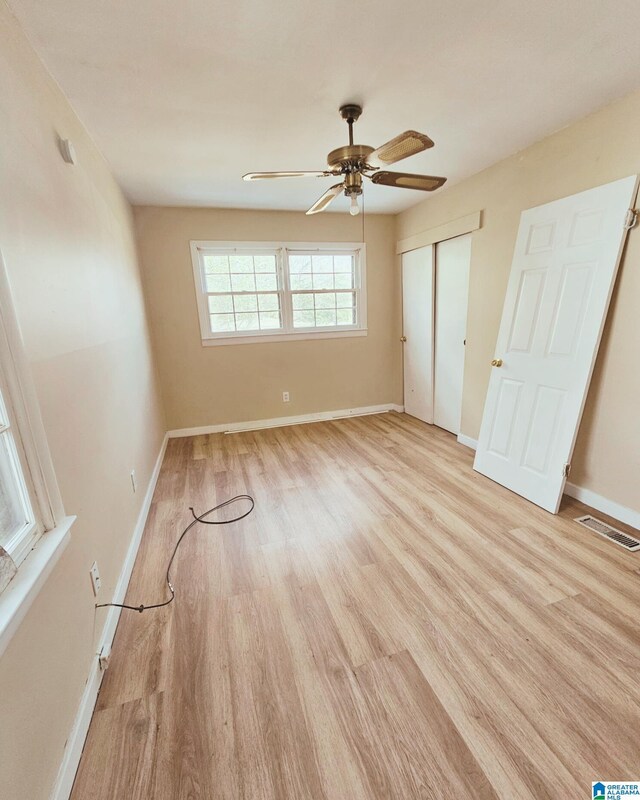 1332 4th Way NW, Center Point, AL 35215 - unfurnished bedroom with light wood-style flooring, baseboards, a closet, and a ceiling fan