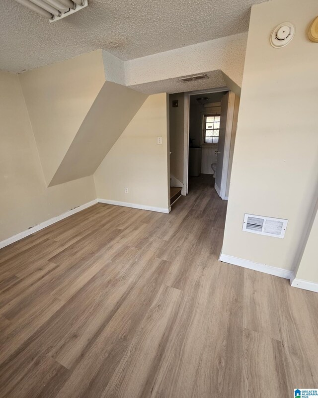 1332 4th Way NW, Center Point, AL 35215 - bonus room with a textured ceiling, wood finished floors, baseboards, and stairway