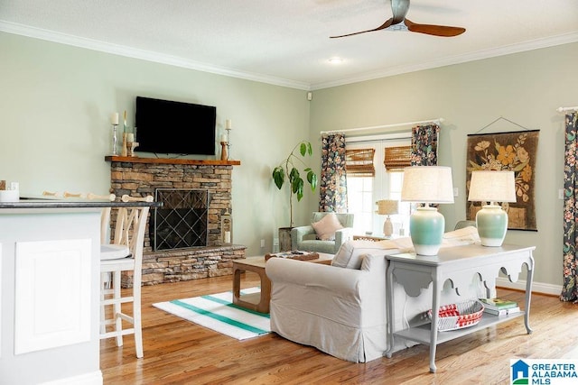967 Wright Way Dr, Wedowee, AL 36278 - living room with wood finished floors, ornamental molding, a ceiling fan, a stone fireplace, and baseboards