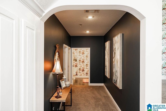 967 Wright Way Dr, Wedowee, AL 36278 - hallway featuring arched walkways, carpet, a textured ceiling, and baseboards