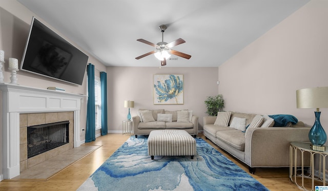 6303 Letson Farms Dr, Bessemer, AL 35022 - living area featuring a ceiling fan, light wood-style floors, a fireplace, and baseboards
