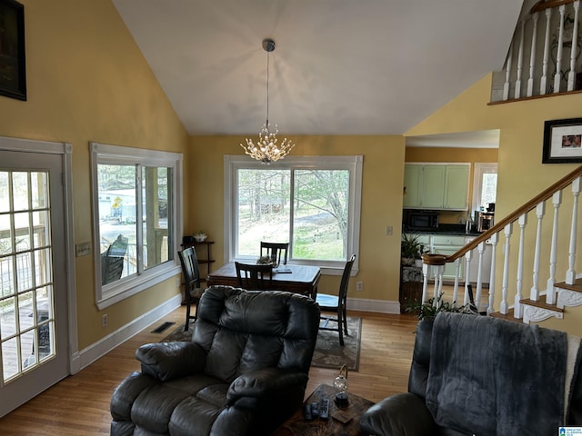 12325 US Highway 411 N, Centre, AL 35960 - living area featuring a chandelier, high vaulted ceiling, baseboards, stairway, and wood finished floors