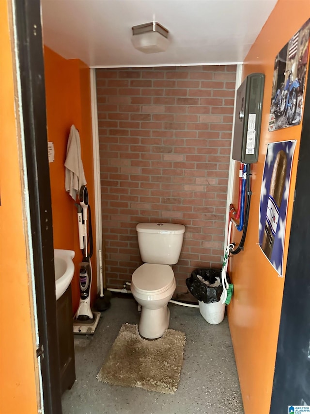 12325 US Highway 411 N, Centre, AL 35960 - bathroom featuring toilet, brick wall, and vanity