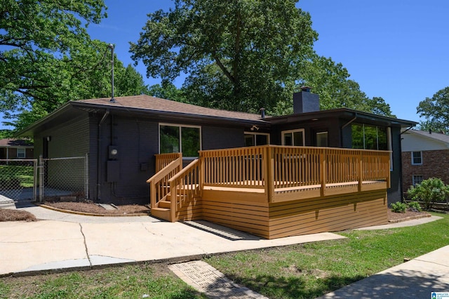 732 Highland Ave, Birmingham, AL 35206 - back of house featuring a wooden deck, a chimney, a gate, and brick siding