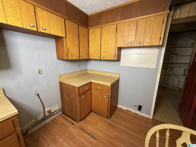 1790 Mount View Rd, Wellington, AL 36279 - kitchen featuring brown cabinets, light wood-style flooring, light countertops, and a textured ceiling