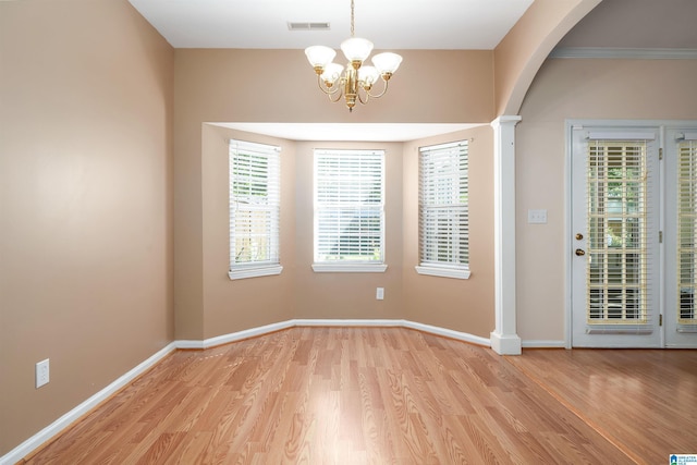 4244 Cobblestone Ct, Pinson, AL 35126 - unfurnished dining area featuring light wood-type flooring, a chandelier, arched walkways, and baseboards