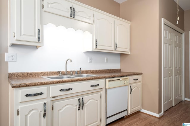 4244 Cobblestone Ct, Pinson, AL 35126 - kitchen featuring dishwasher, a sink, light wood finished floors, baseboards, and white cabinetry
