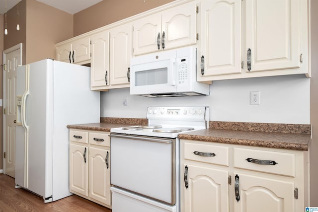 4244 Cobblestone Ct, Pinson, AL 35126 - kitchen featuring white appliances, dark countertops, light wood-style flooring, and white cabinets