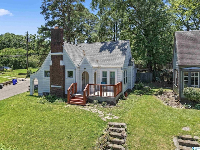 784 80th St, Birmingham, AL 35206 - view of front of house featuring a wooden deck, a front yard, a chimney, and a shingled roof