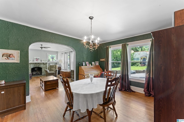 784 80th St, Birmingham, AL 35206 - dining room with a textured wall, wood finished floors, arched walkways, healthy amount of natural light, and ornamental molding