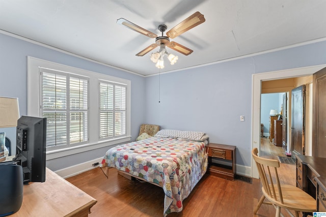 784 80th St, Birmingham, AL 35206 - bedroom with baseboards, wood finished floors, ornamental molding, and ceiling fan