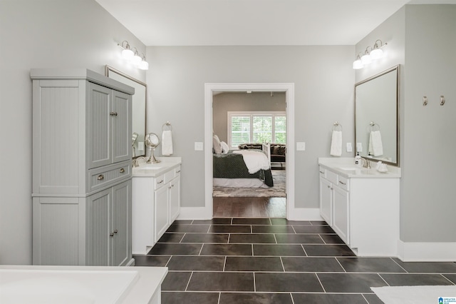 2021 Kinzel Ln, Birmingham, AL 35242 - ensuite bathroom with two vanities, tile patterned flooring, and baseboards