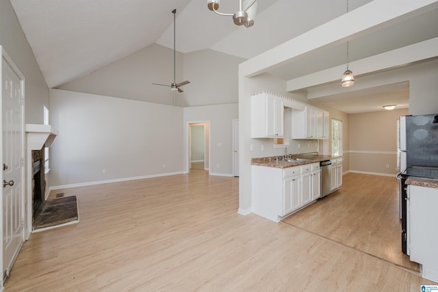 1012 Hickory St, Moody, AL 35004 - kitchen featuring stainless steel appliances, white cabinetry, a fireplace with raised hearth, a sink, and open floor plan