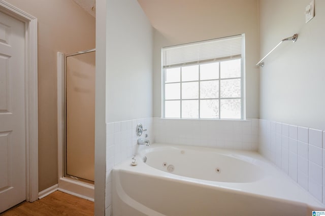 1012 Hickory St, Moody, AL 35004 - bathroom featuring a jetted tub, a shower stall, and wood finished floors