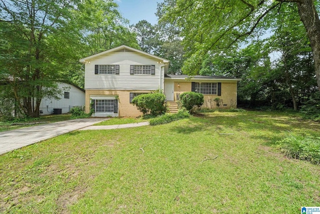 1716 Nancy Ln, Center Point, AL 35215 - tri-level home featuring a front lawn, view of wooded area, and concrete driveway