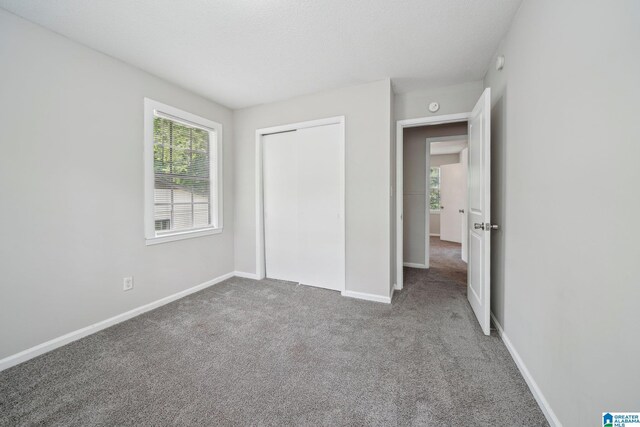 1716 Nancy Ln, Center Point, AL 35215 - unfurnished bedroom featuring carpet floors, baseboards, and a closet