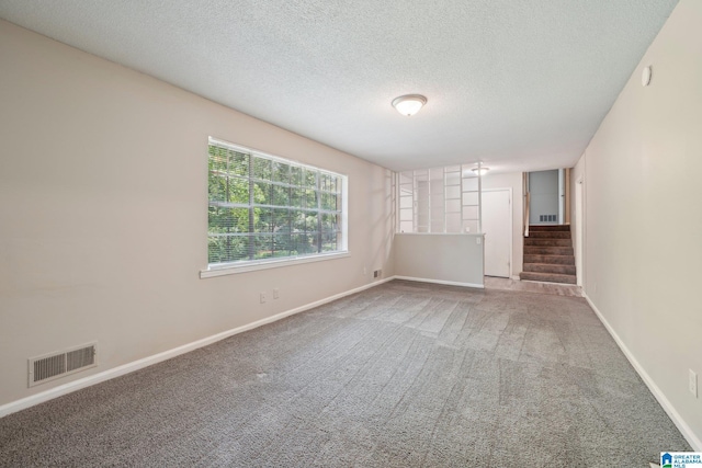 1716 Nancy Ln, Center Point, AL 35215 - carpeted spare room featuring a textured ceiling, stairs, and baseboards
