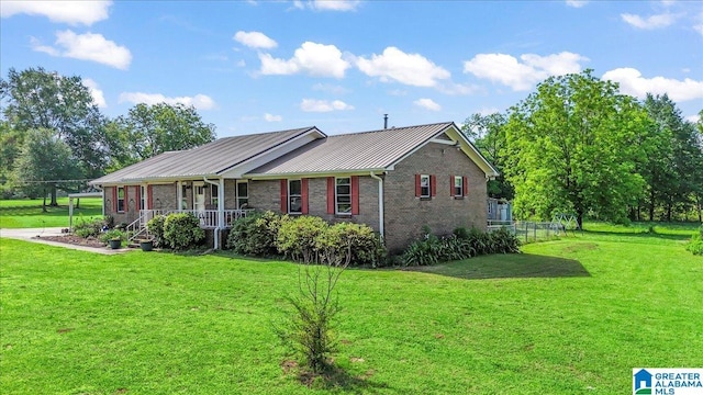 2523 County Road 222, Cullman, AL 35057 - ranch-style home featuring covered porch, a front lawn, metal roof, brick siding, and a standing seam roof