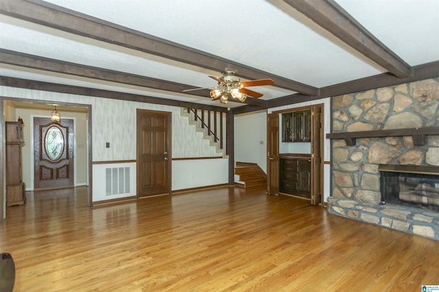 3300 Shetland Trce, Birmingham, AL 35242 - unfurnished living room with stairway, light wood-style floors, ceiling fan, baseboards, and beam ceiling
