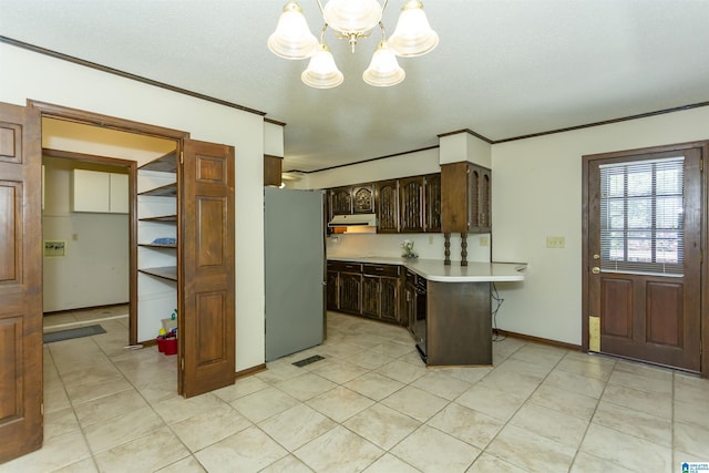 3300 Shetland Trce, Birmingham, AL 35242 - kitchen with freestanding refrigerator, a peninsula, a chandelier, dark brown cabinets, and light countertops