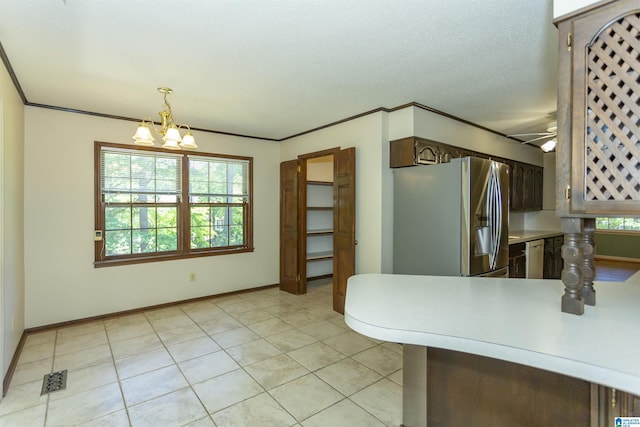3300 Shetland Trce, Birmingham, AL 35242 - kitchen with stainless steel fridge, a chandelier, light countertops, light tile patterned floors, and hanging light fixtures
