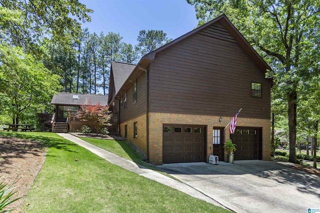 3300 Shetland Trce, Birmingham, AL 35242 - view of home's exterior featuring an attached garage, concrete driveway, a wooden deck, a lawn, and brick siding