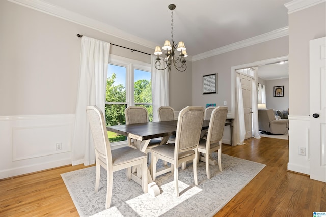 1709 Wakefield Dr, Hoover, AL 35216 - dining room featuring a chandelier, crown molding, wood finished floors, and a wainscoted wall