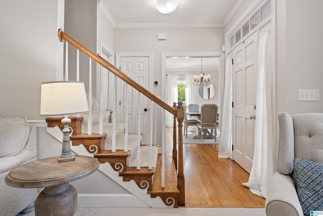 1709 Wakefield Dr, Hoover, AL 35216 - entryway with ornamental molding, stairs, a chandelier, and wood finished floors
