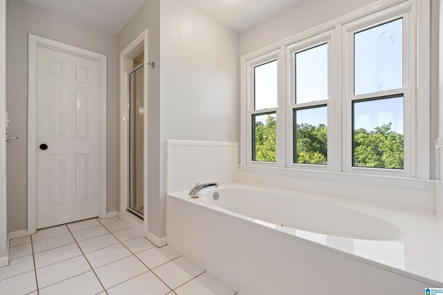 1709 Wakefield Dr, Hoover, AL 35216 - full bathroom featuring a garden tub, tile patterned flooring, a stall shower, and baseboards