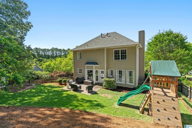 1709 Wakefield Dr, Hoover, AL 35216 - rear view of property featuring a chimney, a playground, an outdoor hangout area, and a patio area