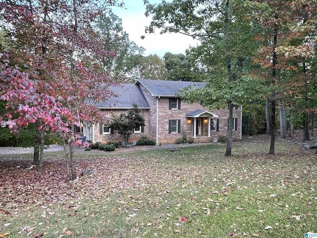 2301 Hathaway Heights Rd, Anniston, AL 36207 - view of front of property featuring brick siding, a front yard, and a shingled roof