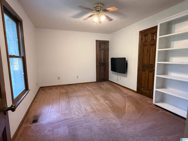 2301 Hathaway Heights Rd, Anniston, AL 36207 - empty room with carpet flooring, a ceiling fan, and baseboards