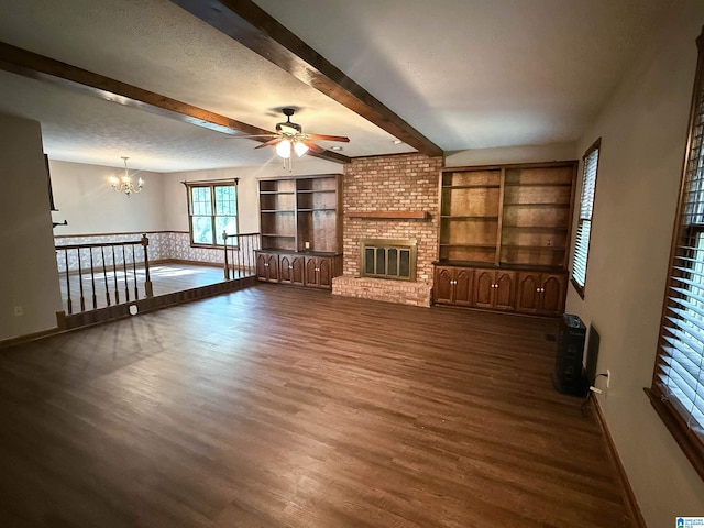 2301 Hathaway Heights Rd, Anniston, AL 36207 - unfurnished living room featuring dark wood-type flooring, ceiling fan, beam ceiling, a chandelier, and baseboards