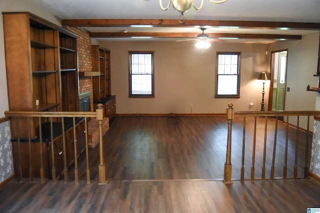 2301 Hathaway Heights Rd, Anniston, AL 36207 - unfurnished living room with wood finished floors, beam ceiling, plenty of natural light, and baseboards