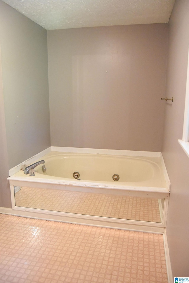2301 Hathaway Heights Rd, Anniston, AL 36207 - bathroom with a jetted tub, tile patterned floors, and baseboards